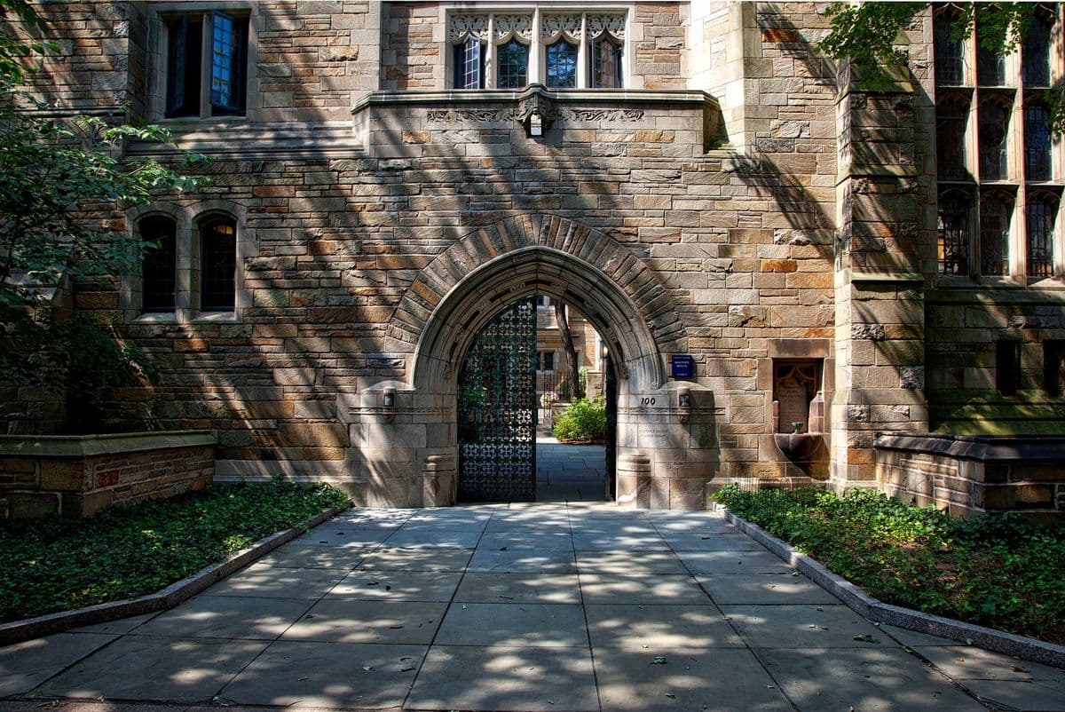 Stone gothic archway with an open iron gate